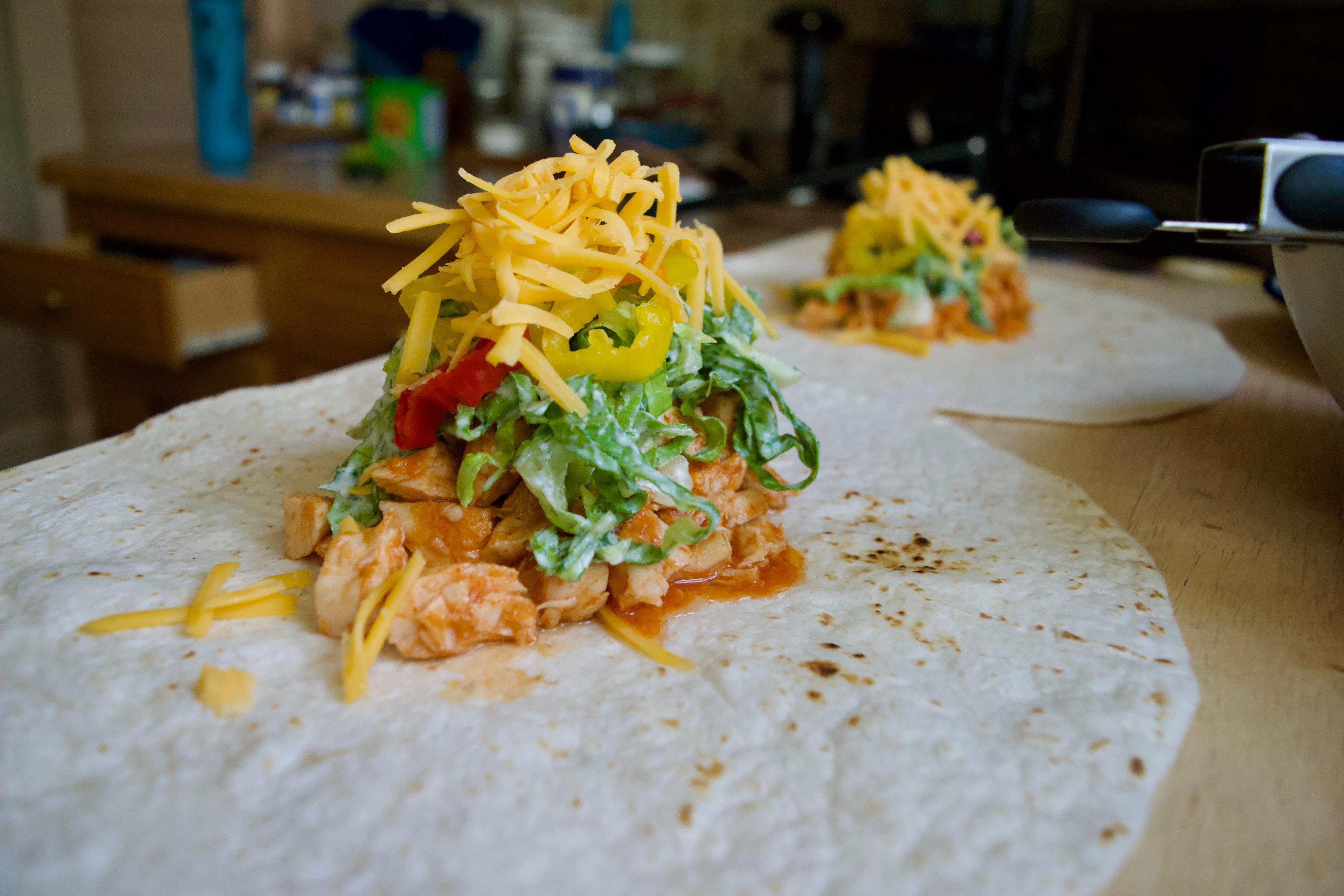 Wrap ingredients piled up on a tortilla