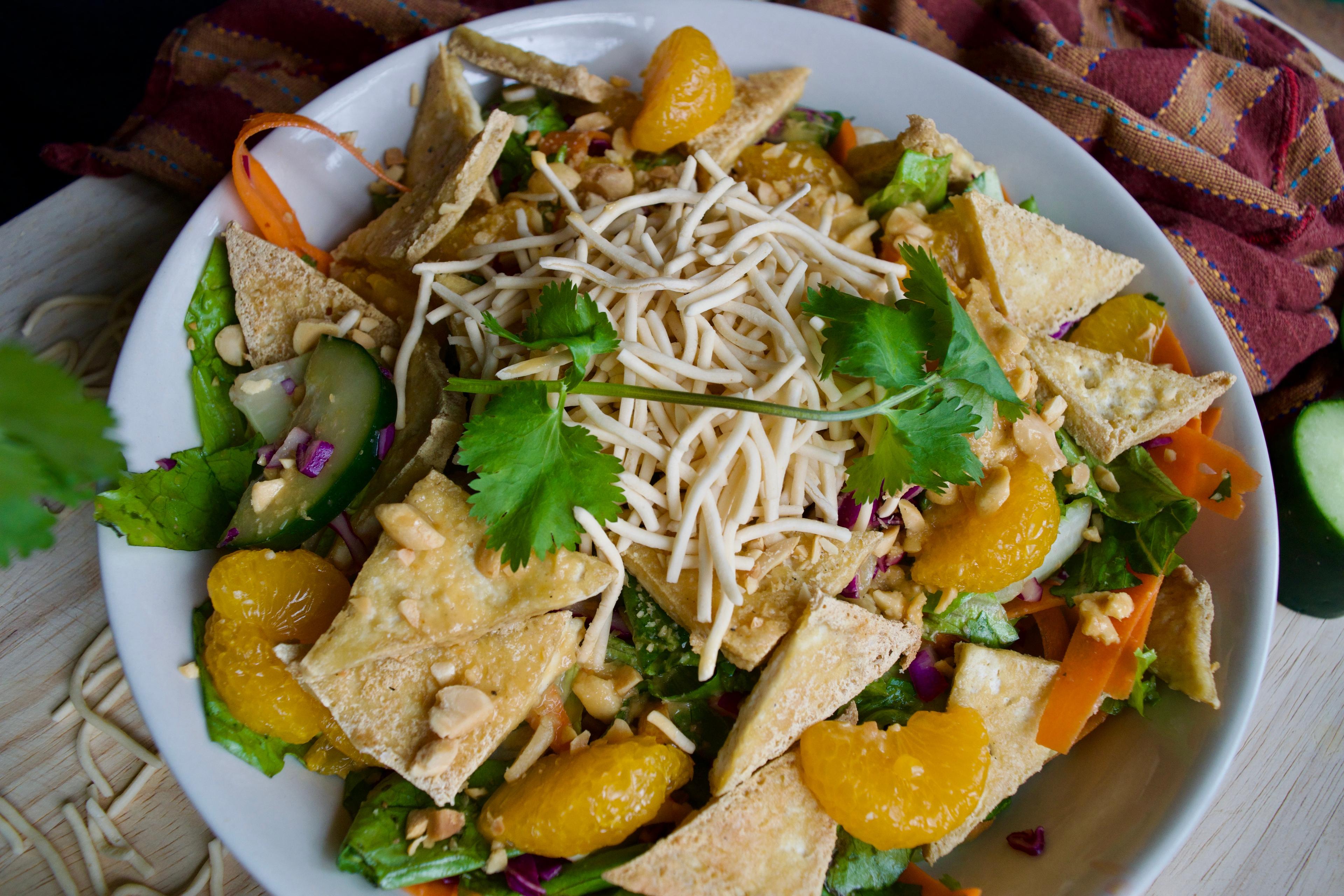 Completed salad close up - fried tofu, mandarin oranges, cucumber, and cilantro are all very visible.