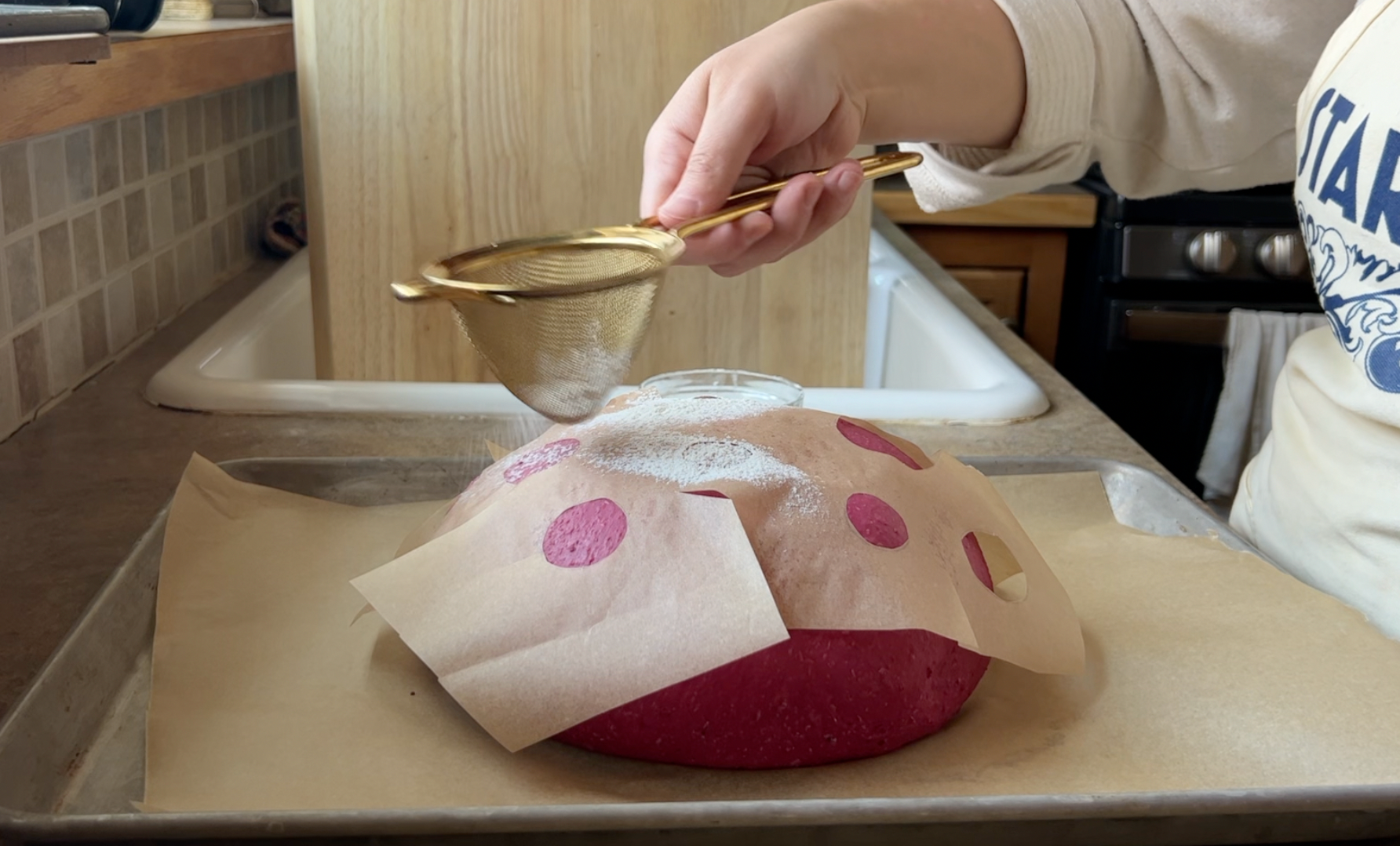 Dusting flour over the beet bread