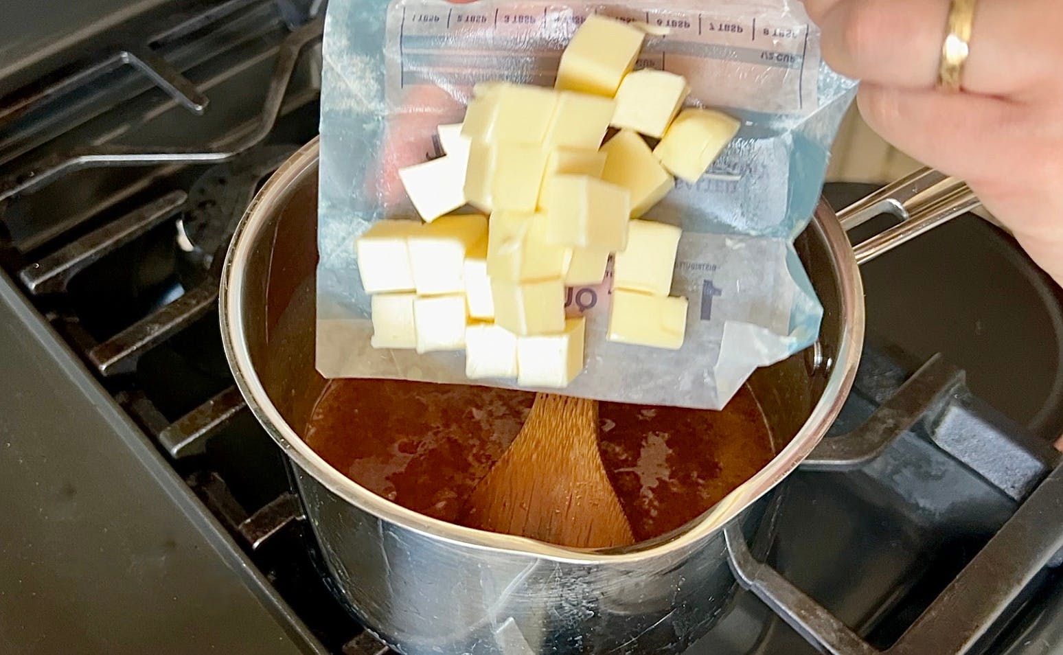 Putting cubed butter in the caramel