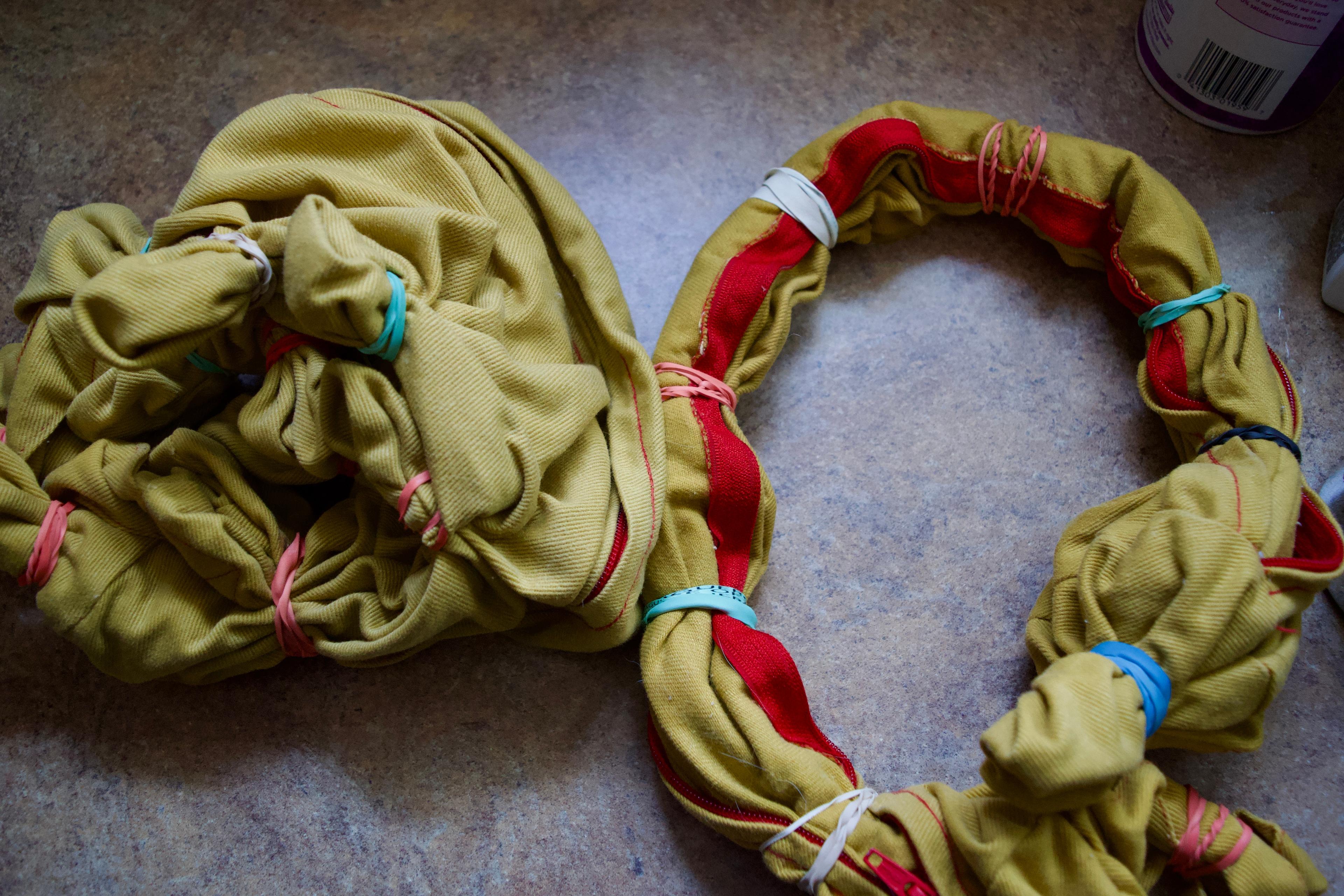 Yellow yoga bolster covers tied up in different patterns with rubber bands