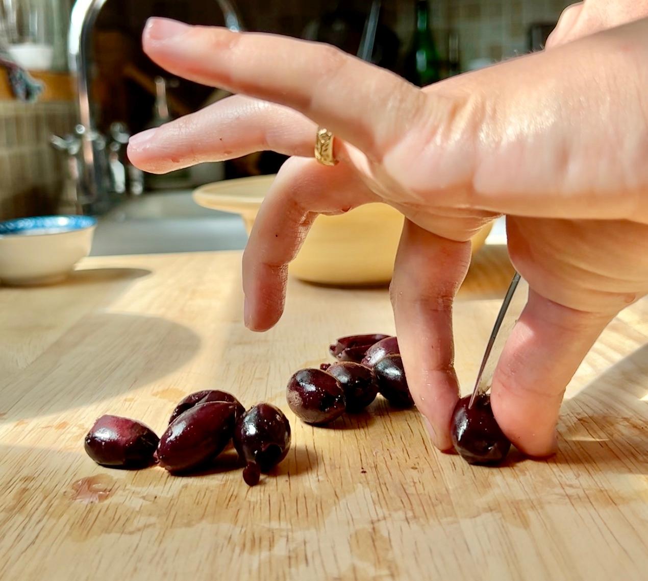 Cutting olives in half