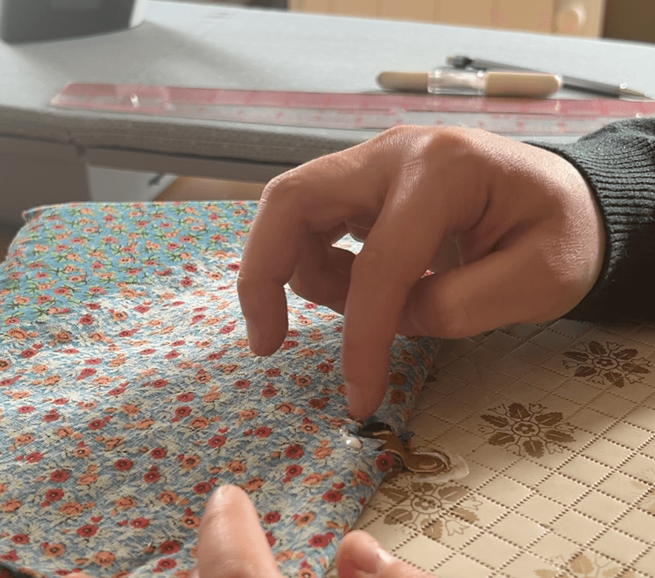 Gluing fabric around the hardware of the handle