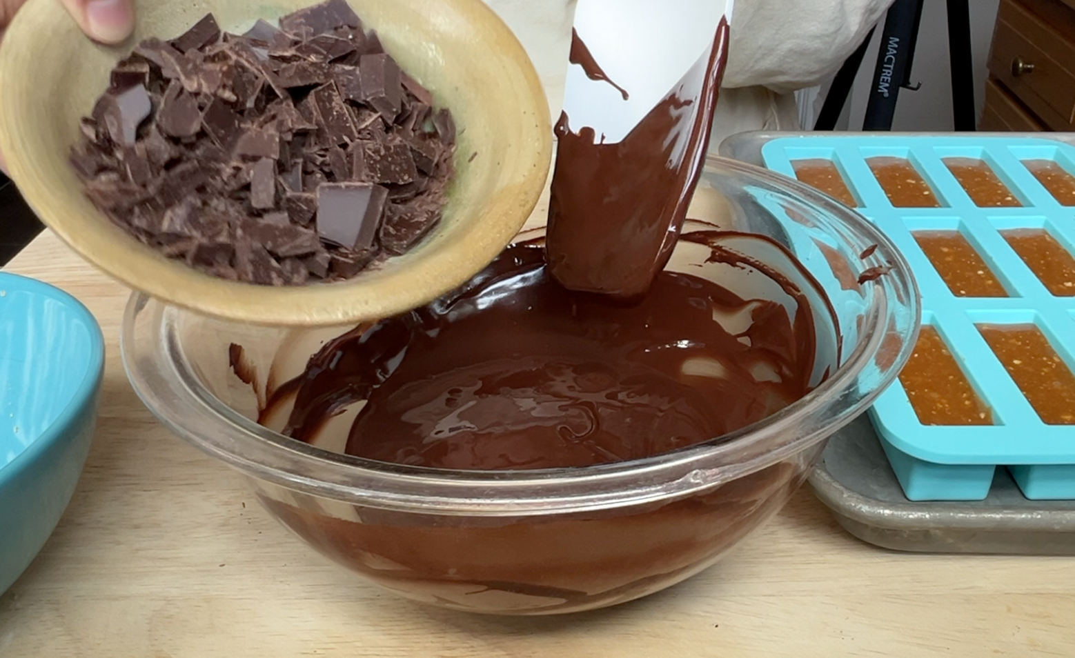 Adding chopped chocolate to melted chocolate