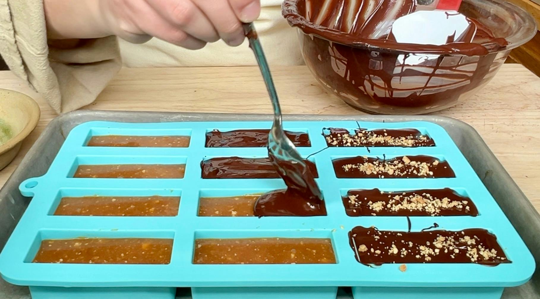Spooning chocolate into the molds.