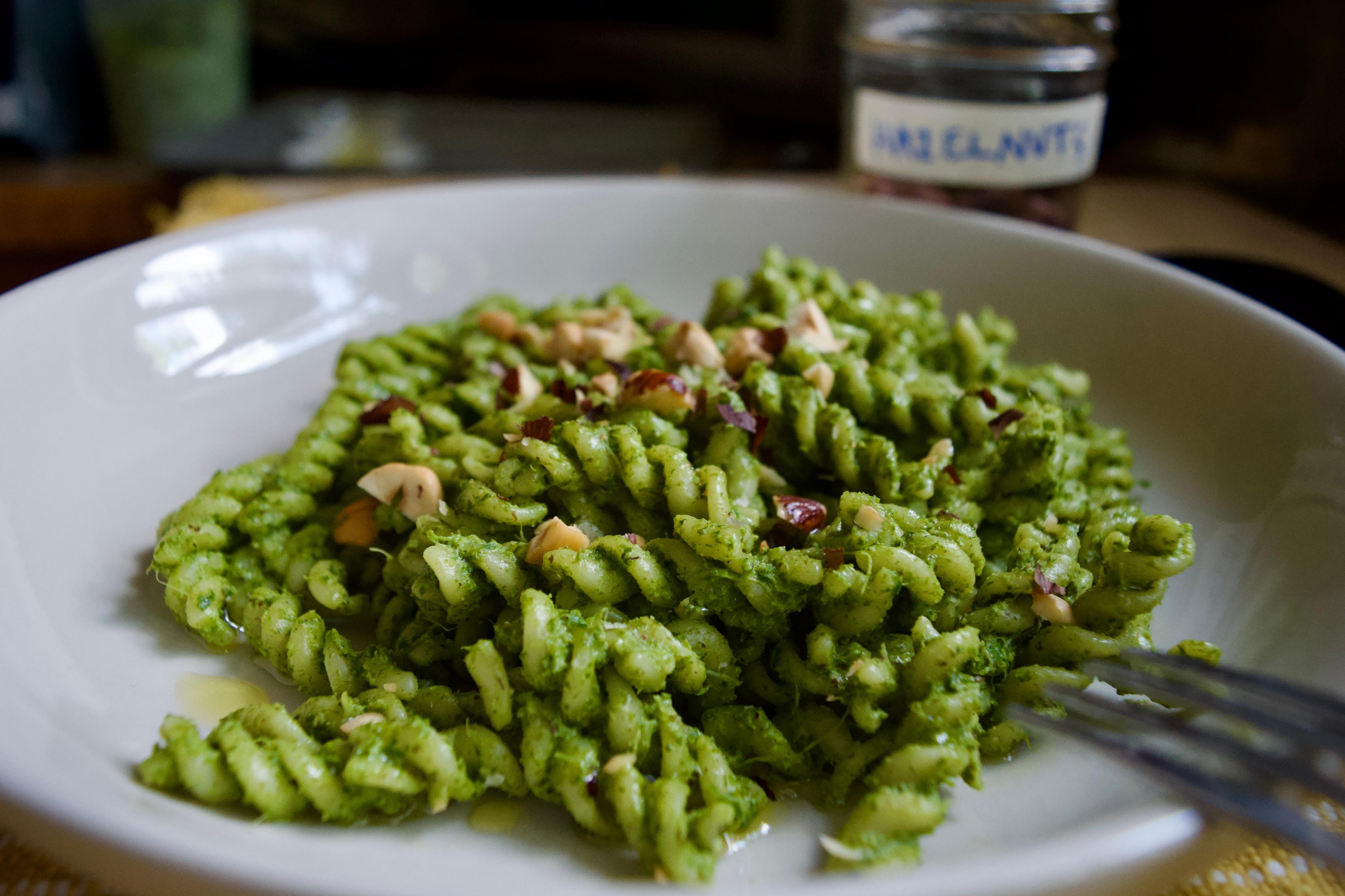 A close up view of plated pesto pasta