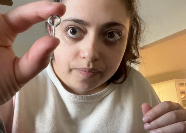 Holding a screw eye up to the camera