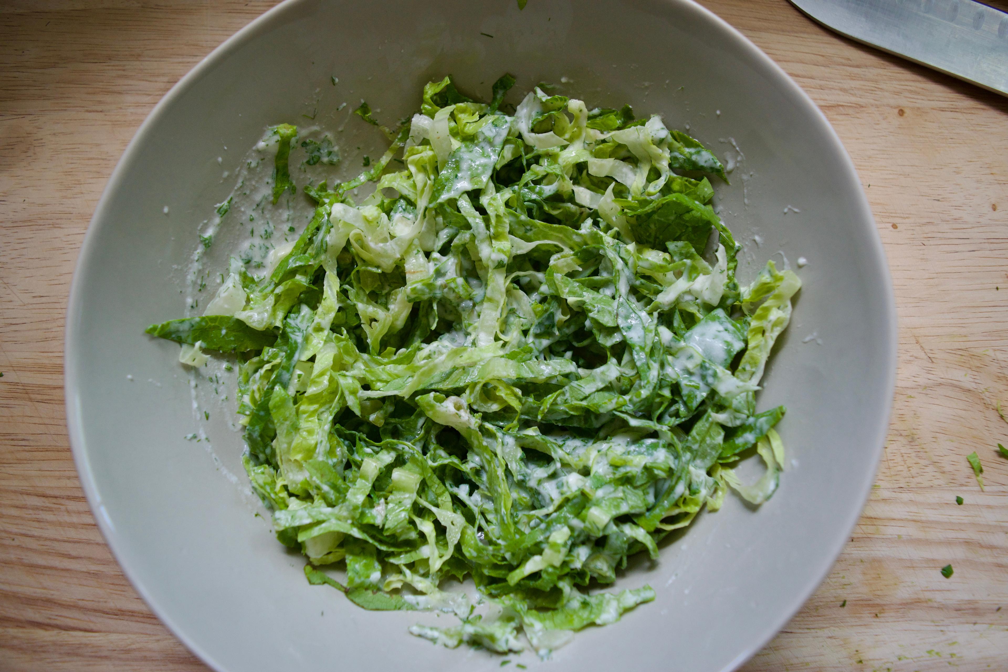 Dressed shredded romaine in a bowl